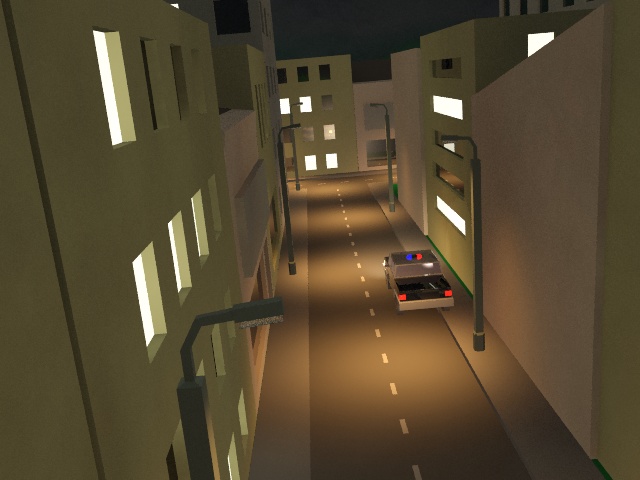 A police car parked in an empty street at night.